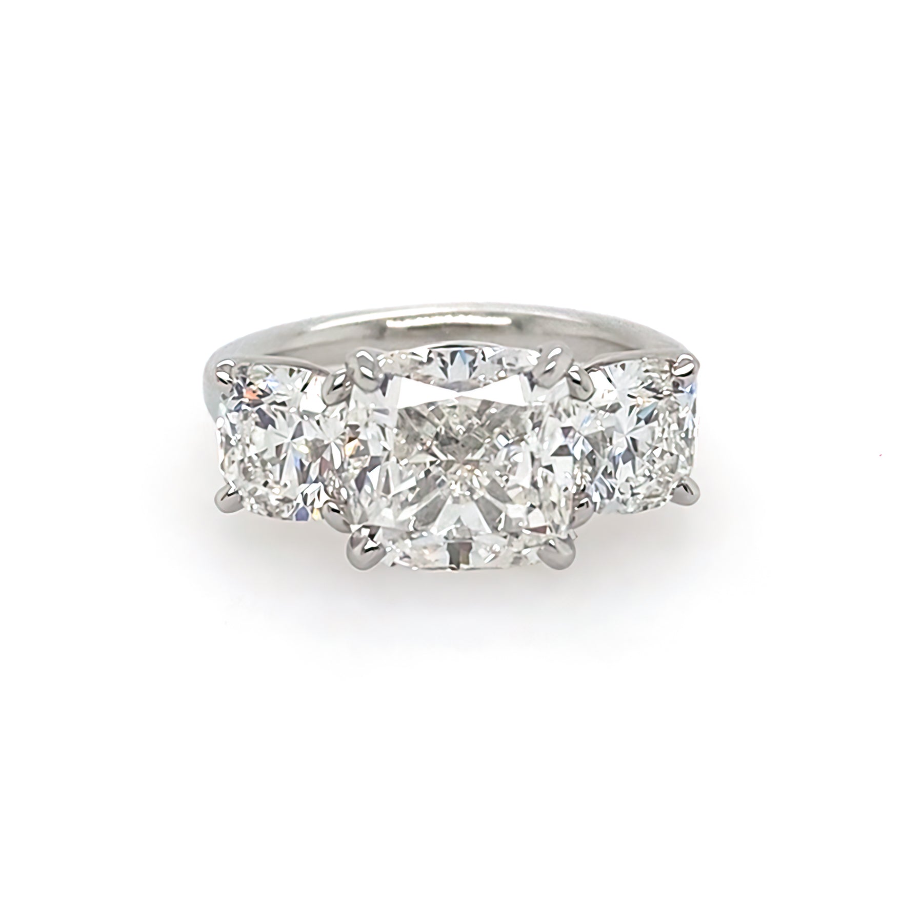 front view of custom designed three stone diamond cushion cut ring set in platinum