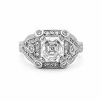 An antique-style diamond ring featuring a large Asscher-cut center stone surrounded by smaller round diamonds on a platinum filigree band, set against a plain white background.