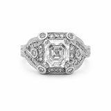 An antique-style diamond ring featuring a large Asscher-cut center stone surrounded by smaller round diamonds on a platinum filigree band, set against a plain white background.
