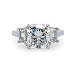 A platinum cushion cut diamond ring with side trapezoid diamonds
