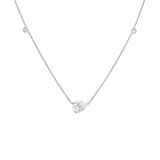 A platinum necklace with a solitaire diamond pendant surrounded by smaller clear crystals.