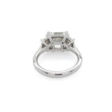 A platinum diamond ring featuring a rectangular east to west center diamond and smaller side diamonds, shown on a plain white background.