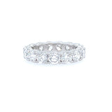 A custom-designed platinum band ring with prong set diamonds.
