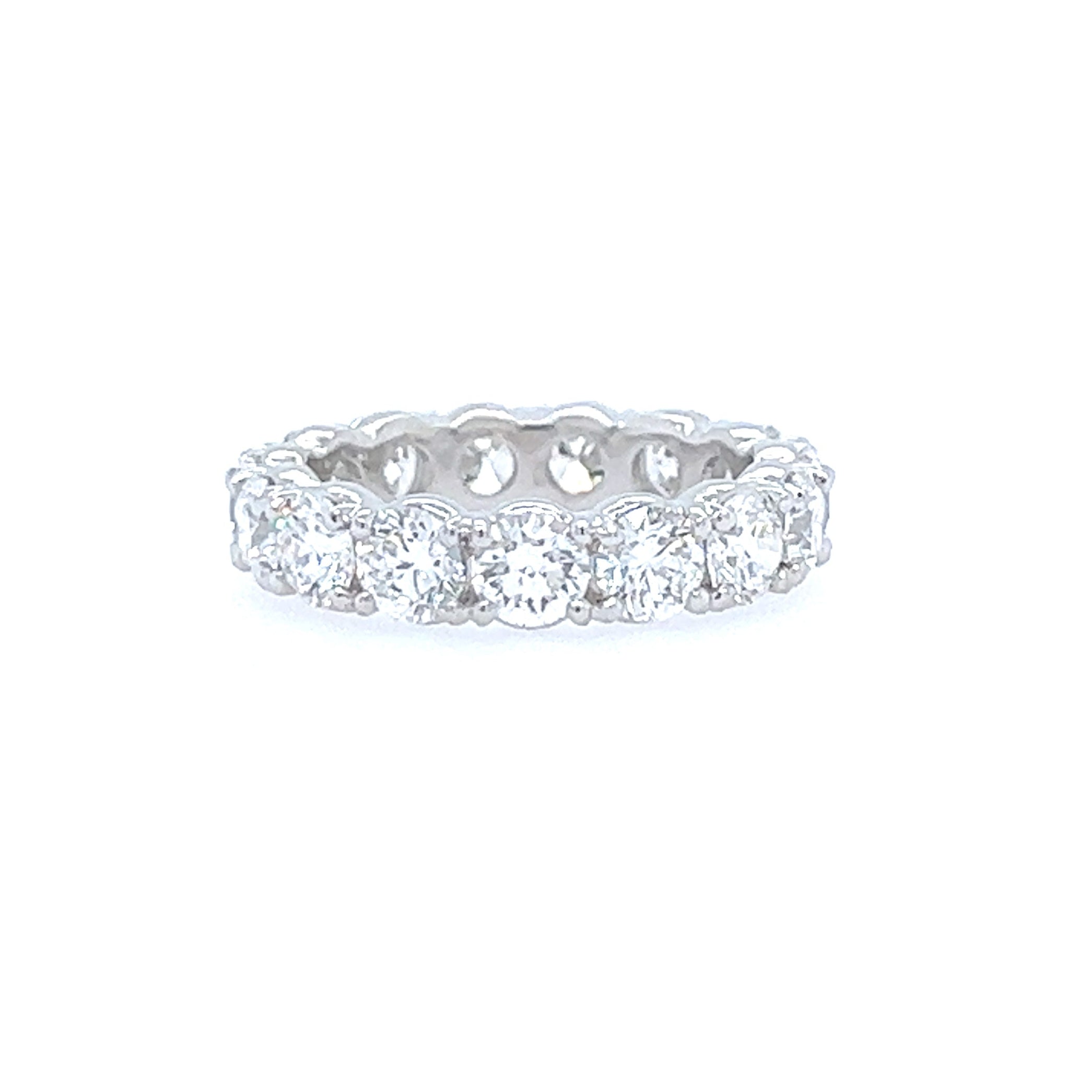 A custom-designed platinum band ring with prong set diamonds.