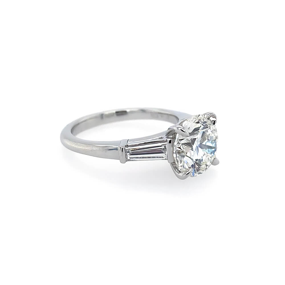 A classic solitaire diamond ring with a brilliant-cut center stone in a platinum metal setting, shown on a clean white background.