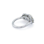 A platinum ring with a three diamonds with diamond halos