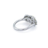 A platinum ring with a three diamonds with diamond halos