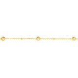 A delicate 18K yellow gold chain bracelet featuring small round bezel-set clear diamonds spaced evenly along the chain, shown against a plain white background.