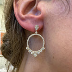 Woman wearing diamond circle dangle earrings 