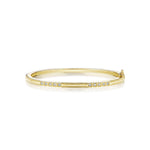 An 18K yellow gold bangle with a diamond box set pattern, designed by Penny Preville