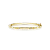 An 18K yellow gold bangle with a diamond box set pattern, designed by Penny Preville