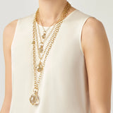 18K Gold chain necklaces with a rock crystal and diamond pendant on a white background
