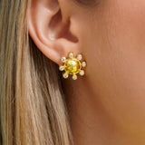 Close-up of a woman wearing a 19K yellow gold earring with diamonds 