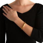 19K Gold bracelet designed by Elizabeth Locke on a woman's wrist 