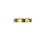 19K Gold ring with green Tsavorite gemstones on a white background