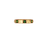 19K Gold ring with green Tsavorite gemstones on a white background