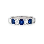 Ring with sapphire gemstones and diamonds on a white background