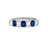 Ring with sapphire gemstones and diamonds on a white background
