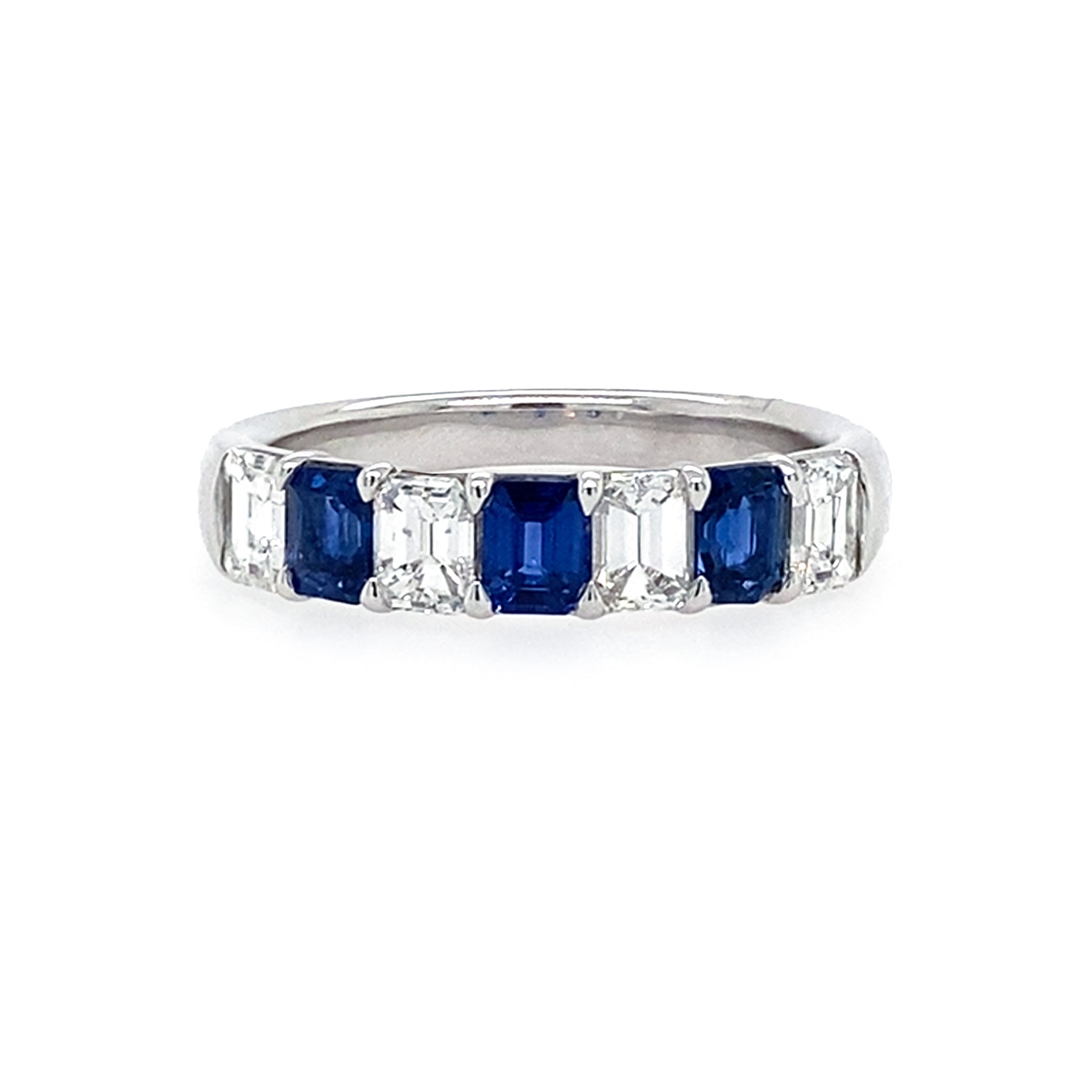 Ring with sapphire gemstones and diamonds on a white background
