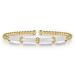 14k yellow gold bangle with white enamel bar on the front