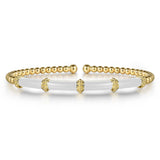 14k yellow gold bangle with white enamel bar on the front