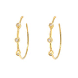 A pair of Estate 18K yellow gold hoop earrings with diamond accents.