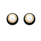Pair of Estate earrings with black and gold circular design with large center Pearls on a white background 