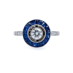 Estate Diamond ring with a Bulls Eye Diamond and Sapphire gemstones on a white background