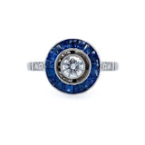 Estate Diamond ring with a Bulls Eye Diamond and Sapphire gemstones on a white background