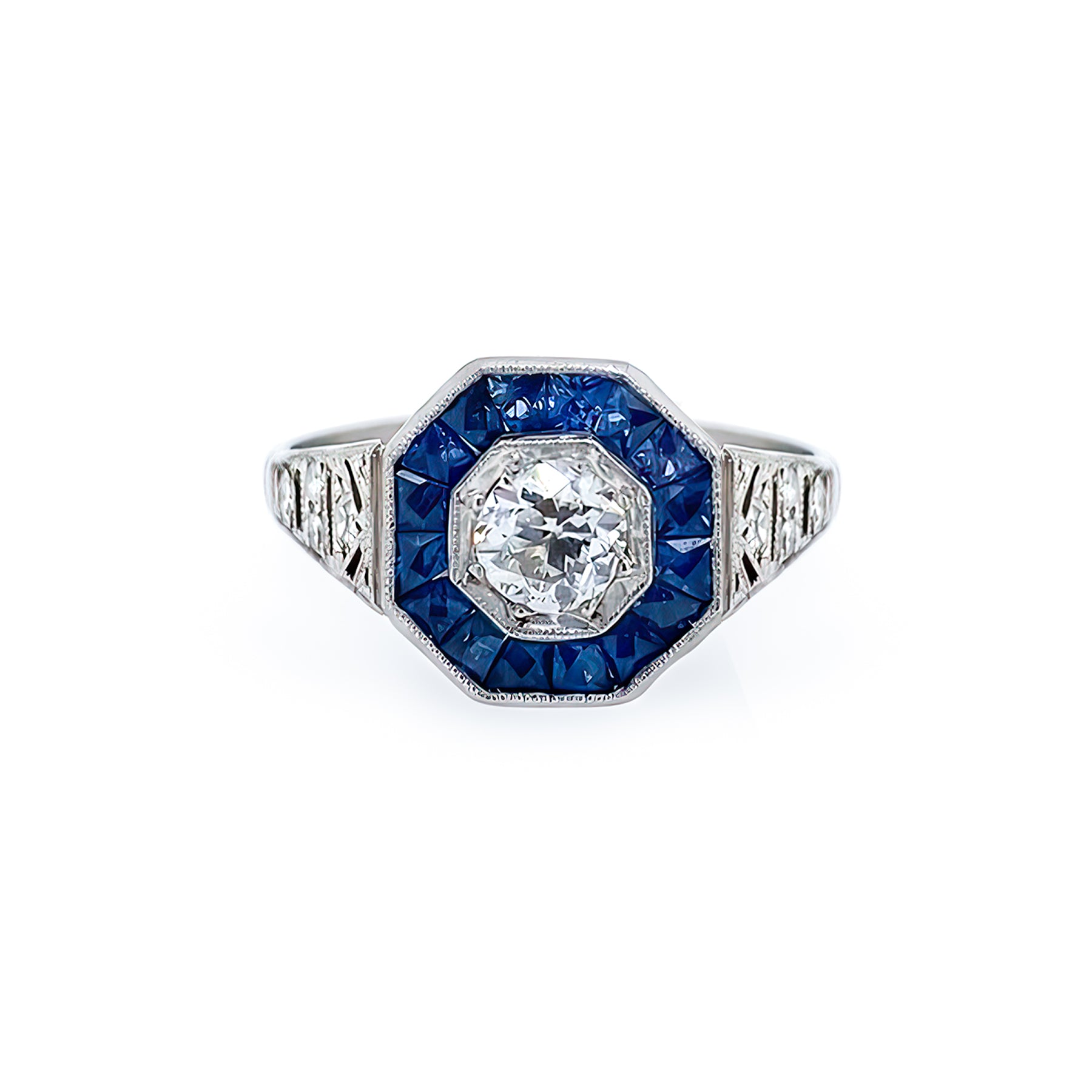 Elegant Estate Platinum ring with Sapphires and a diamond on a white background
