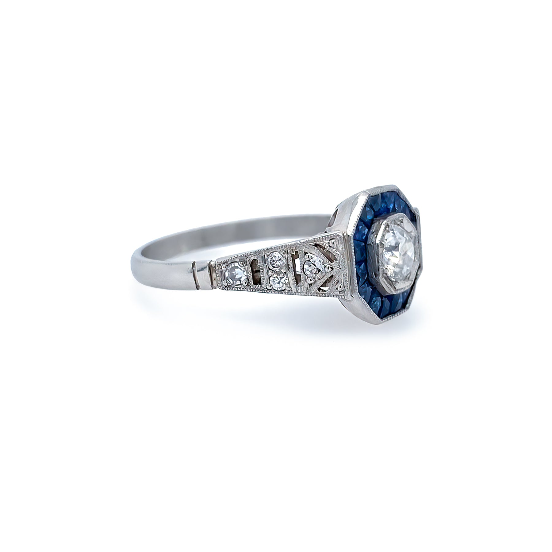 estate Platinum ring with sapphires and diamonds on a white background