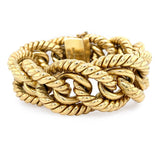 A estate 18K yellow gold twisted rope chain bracelet with a thick rectangular clasp, photographed on a clean white background.