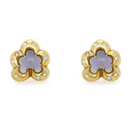 A pair of Estate 18K yellow gold flower-shaped stud earrings with a central lavender-gray moonstone and small clear diamond accents, shown on a plain white background.