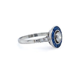 Estate Platinum Bulls Eye Diamond ring with Sapphire and diamond accents on a white background