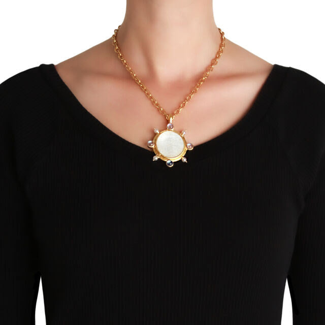 19K Gold necklace with a pendant on a black background