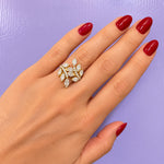 An 18K yellow gold leaf-shaped ring featuring marquise-cut and round brilliant-cut clear diamonds, set against a plain white background.