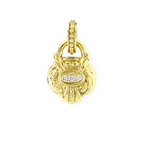 A yellow gold pendant with pave set diamonds, designed in an intricate floral motif style.