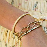 Woman wearing multiple gold bracelets