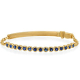 An 18K yellow gold bracelet with blue sapphire stones set in circular patterns along the length of the bracelet.