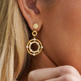 Close-up of a woman wearing 18K yellow gold earrings designed by Gumuchian