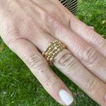Woman wearing a 18K gold stackable rings designed by Gumuchian 