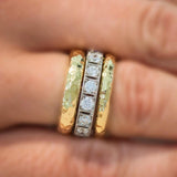 Hammered gold band rings and diamond band rings on model