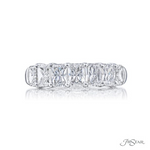 A radiant cut diamond ring with seven stones set in a platinum band.