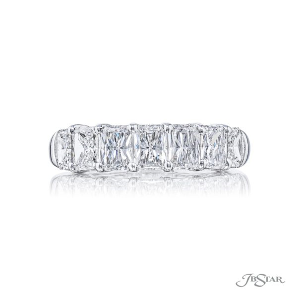 A radiant cut diamond ring with seven stones set in a platinum band.