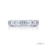 Diamond ring with Asscher cut stones on a white background