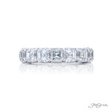 Diamond ring with Asscher cut stones on a white background
