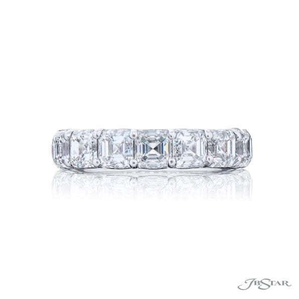 Diamond ring with Asscher cut stones on a white background