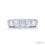 A Radiant cut diamond ring with seven stones set in a platinum band