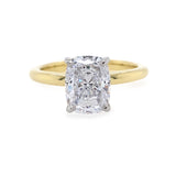 18K Gold ring with a cushion cut diamond on a white background