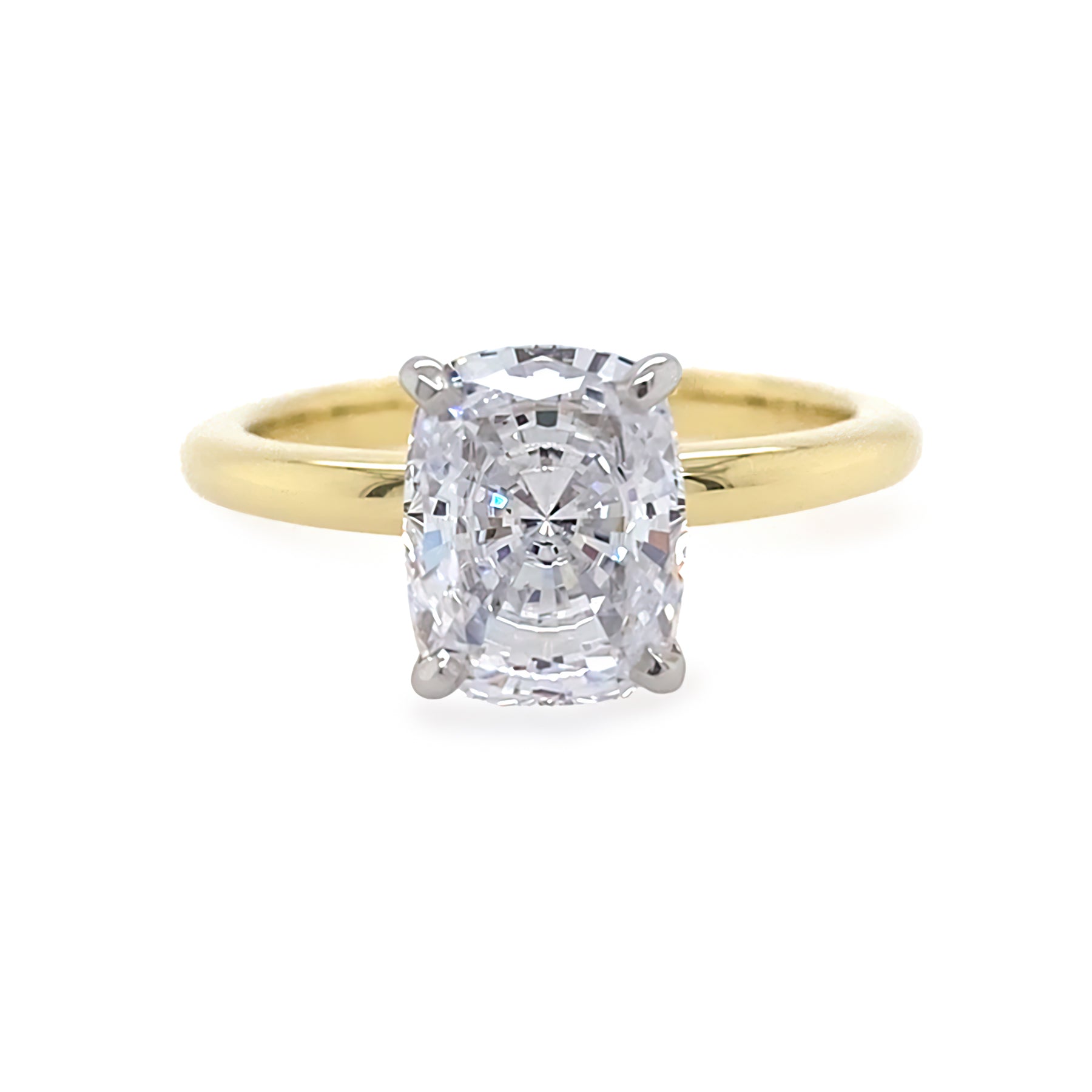 Gold ring with a cushion diamond on a white background